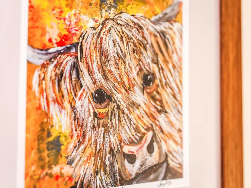 a painting of a dog in a picture at Holiday Home Wester Bunloit by Interhome in Drumnadrochit