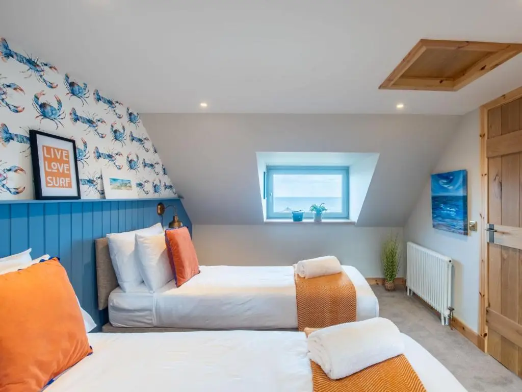 a bedroom with two beds and a window at Holiday Home Cooriedoon by Interhome in Hopeman