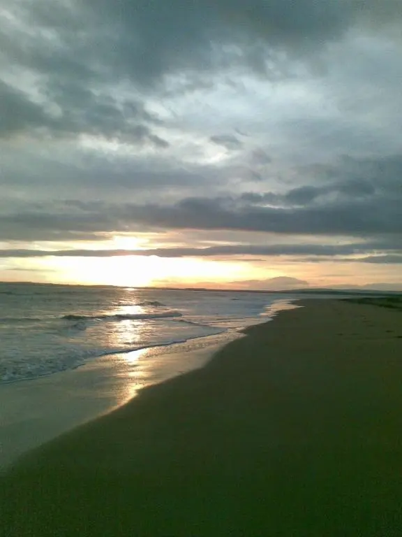 a sunset on a beach with the ocean at Beautiful Highland Sanctuary in Embo