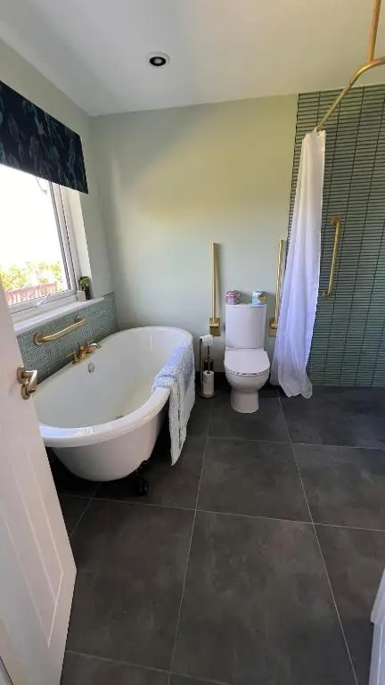 a bathroom with a tub and a toilet at Beautiful Highland Sanctuary in Embo