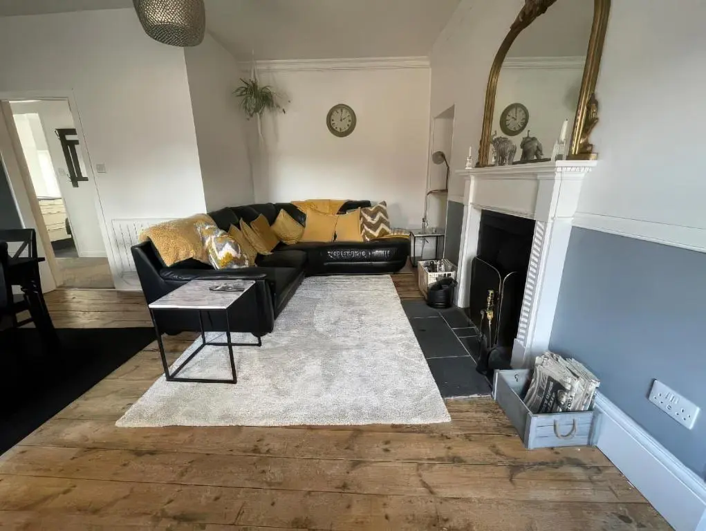 a living room with a couch and a fireplace at Home in Forres, Moray in Forres