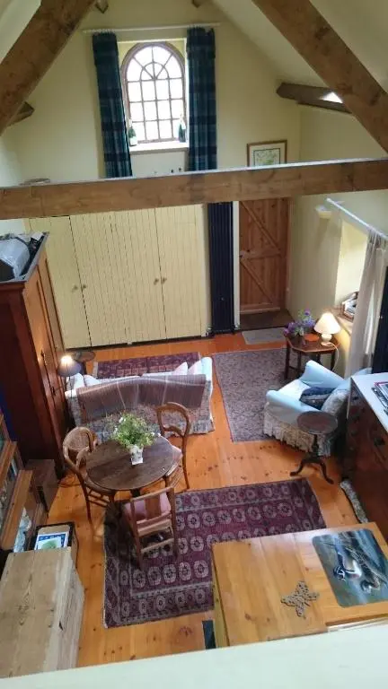 a living room with a couch and a table at Special Offer, Cosy Cottage Near the Sea in Embo in Embo