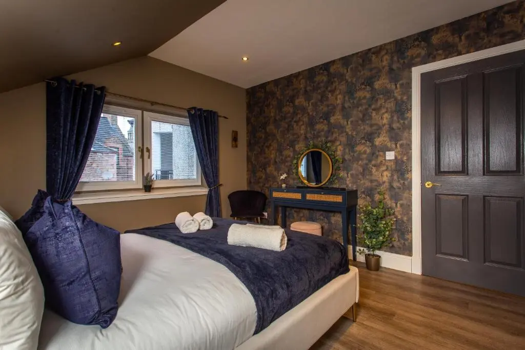 a bedroom with a bed with two towels on it at 17 at the Bell Tower in Inverness