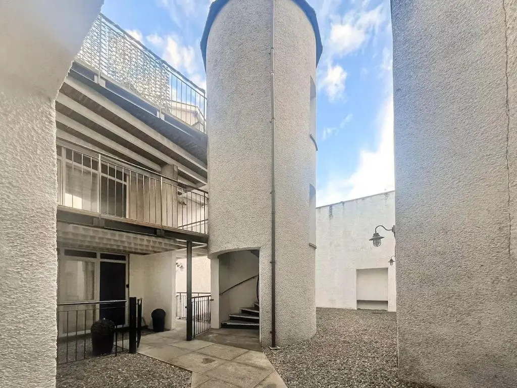 a tall white building with a staircase on the side of it at 17 at the Bell Tower in Inverness