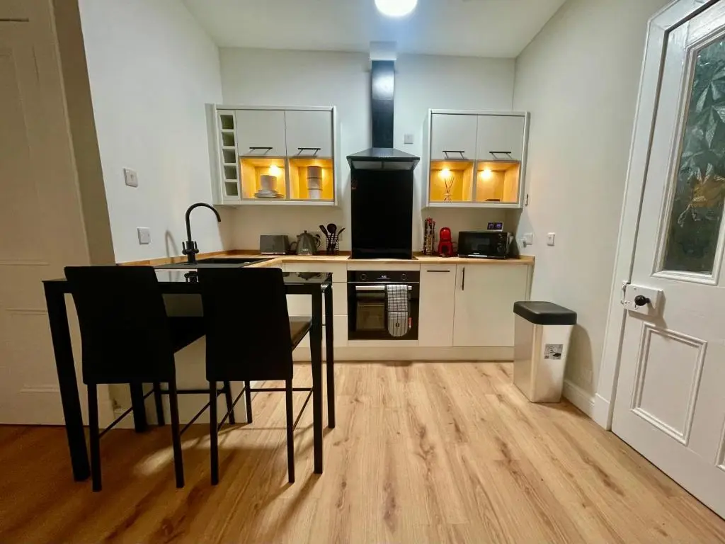 a kitchen with a table and chairs in a room at The Nairn Neuk - Couples Cosy Getaway in Nairn