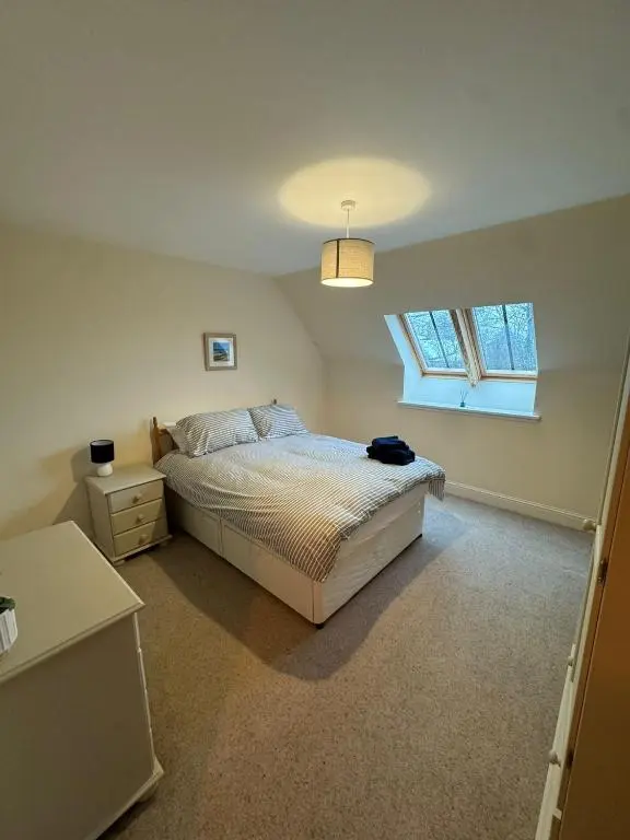 a bedroom with a bed and a window at Turfhill House in New Deer