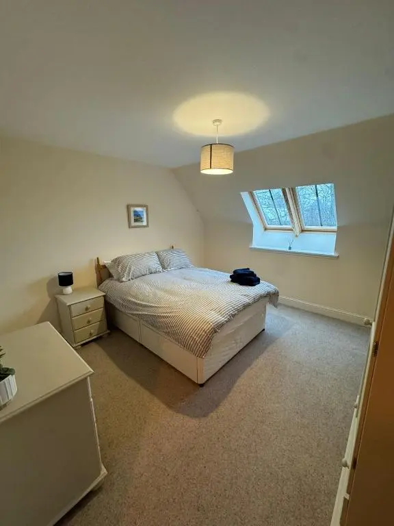 a bedroom with a bed and a window at Turfhill House in New Deer