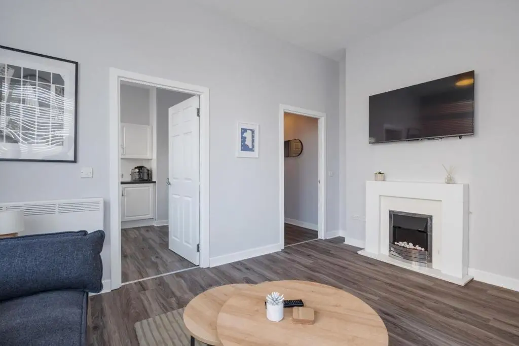 a living room with a couch and a fireplace at Charming 2 bed in Aberchirder in Aberchirder