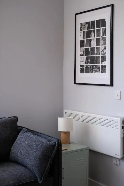 a living room with a couch and a lamp on a table at Charming 2 bed in Aberchirder in Aberchirder