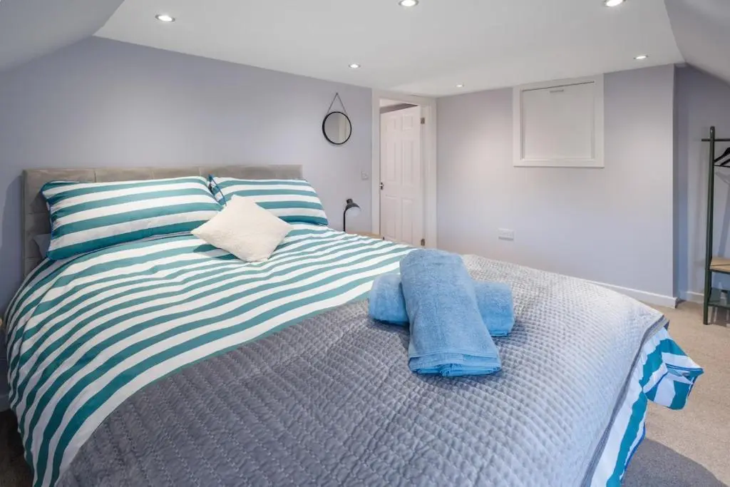 a bedroom with a bed with blue towels on it at Charming 2 bed in Aberchirder in Aberchirder