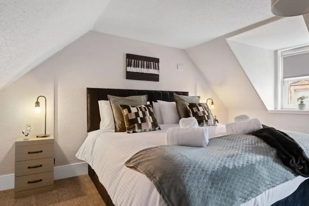 a bedroom with two beds in a attic at Leo Apartment - 4 Bedroom Flat in Nairn in Nairn