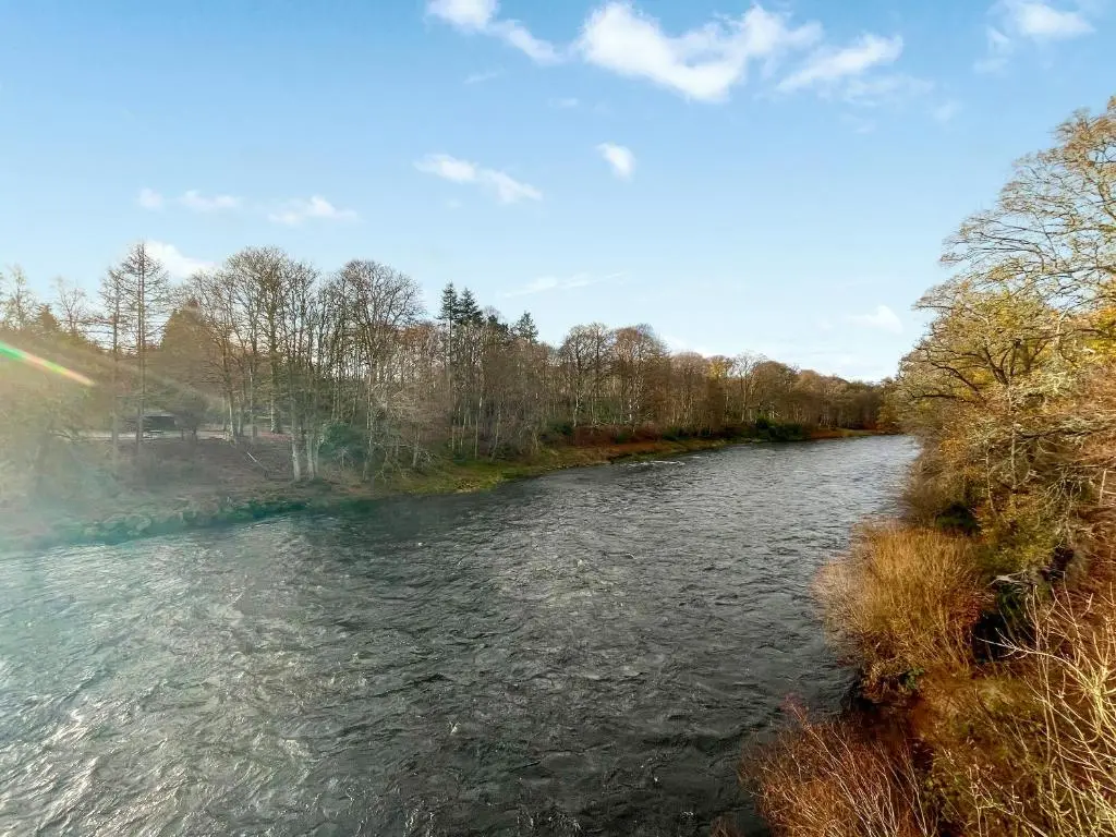 a view of a river with a rainbow at Dee View Apartment in Banchory