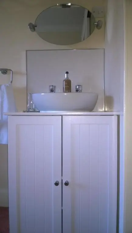 a bathroom with a sink and a white cabinet at Atherstone B&B in Inverness