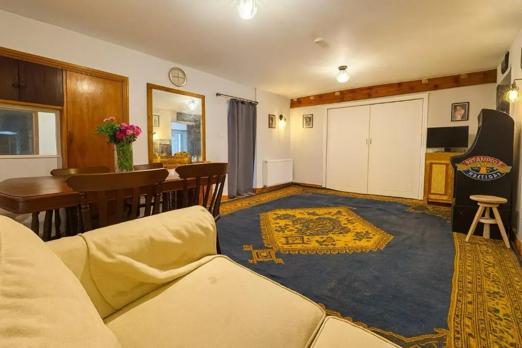 a living room with a couch and a rug at Overscaig House in Lairg