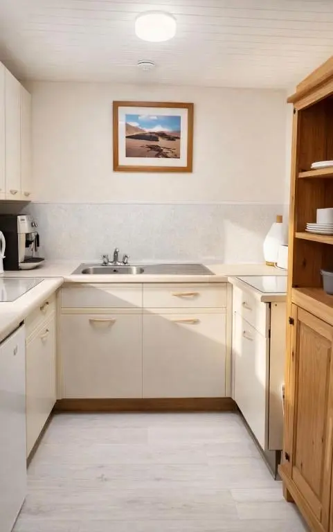 a kitchen with white cabinets and a sink at Overscaig House - The Annexe in Lairg