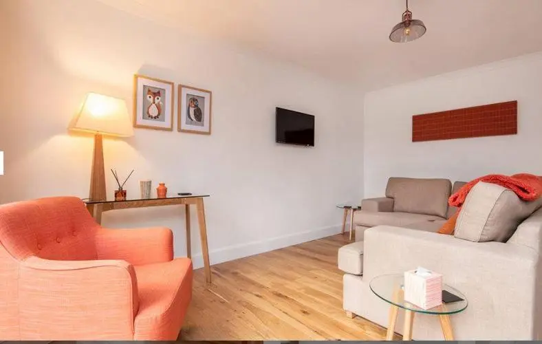 a living room with a couch and a table at 2 Bedroom Macewen Drive in Inverness