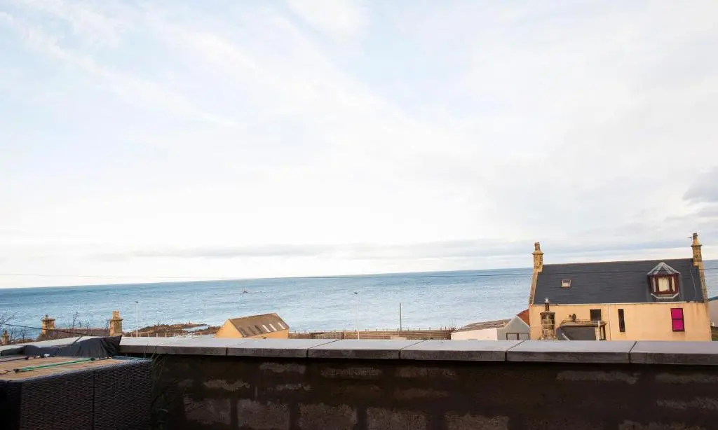 a view of the ocean from the balcony of a house at Rook View, Modern Coastal Retreat with Free Parking in Buckie
