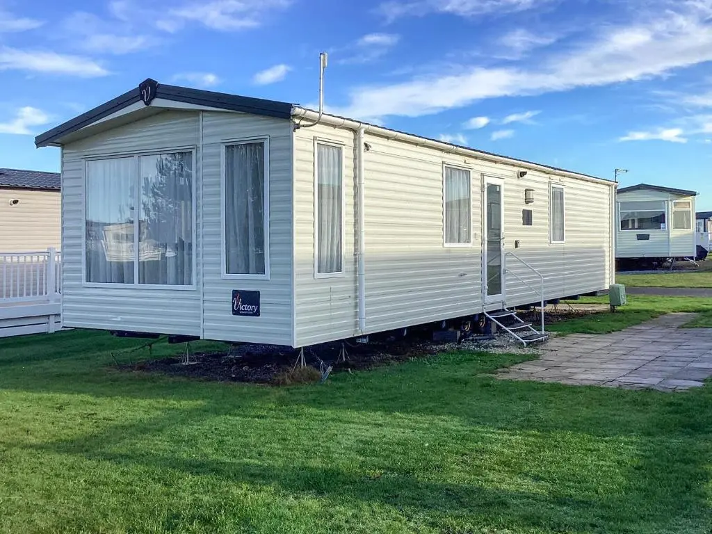 a white mobile home parked in a yard at A Stone's Throw in Lossiemouth