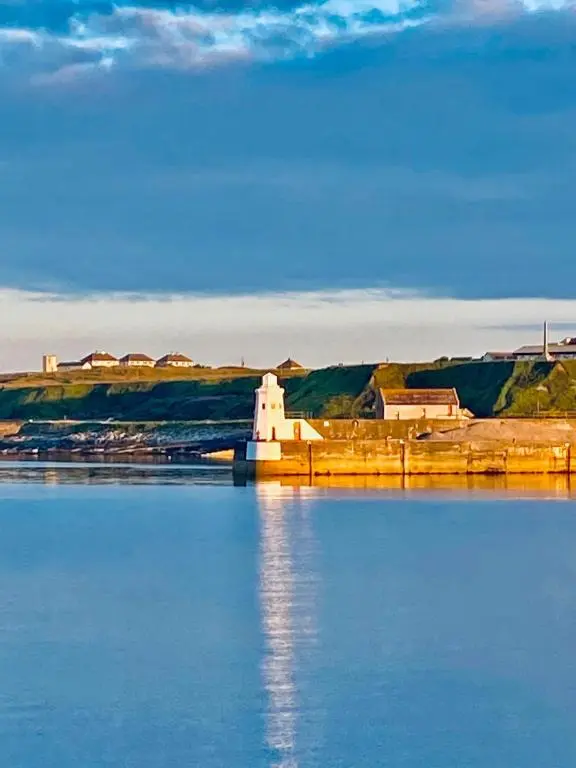 a bridge over a body of water with a building at Newly Renovated Luxuary Flat overlooking Wick Bay in Wick