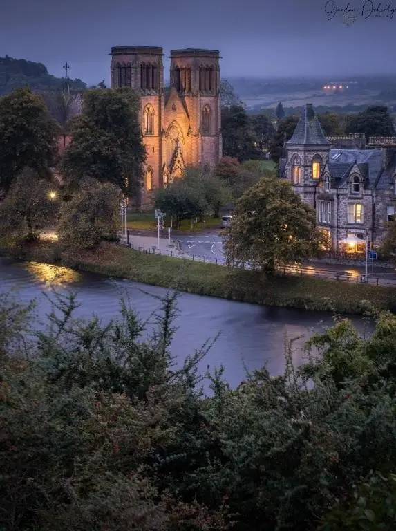 an old building with a river in front of it at City Centre 3 Bedroom house with parking in Dalneigh