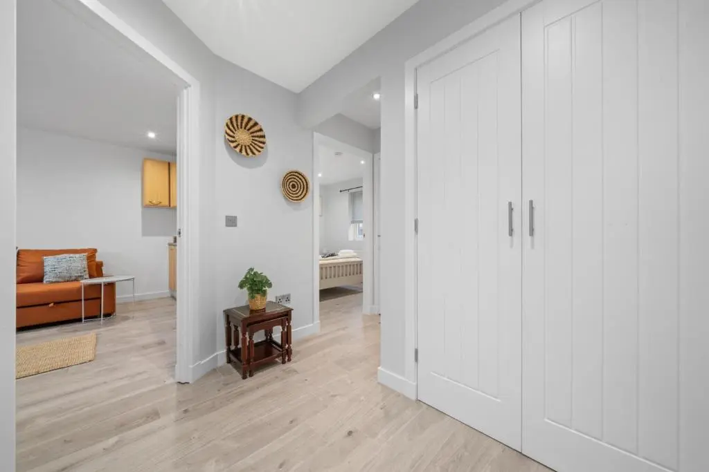 a living room with white walls and a large closet at Temple 1 Bedroom Studio - Inverness in Inverness