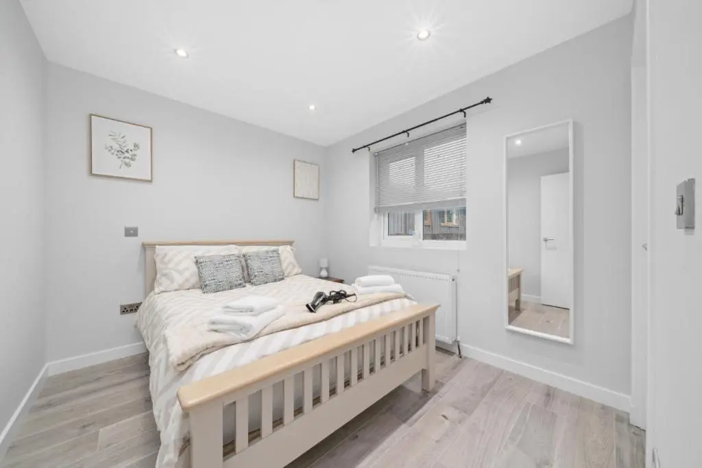 a white bedroom with a bed and a window at Temple 1 Bedroom Studio - Inverness in Inverness