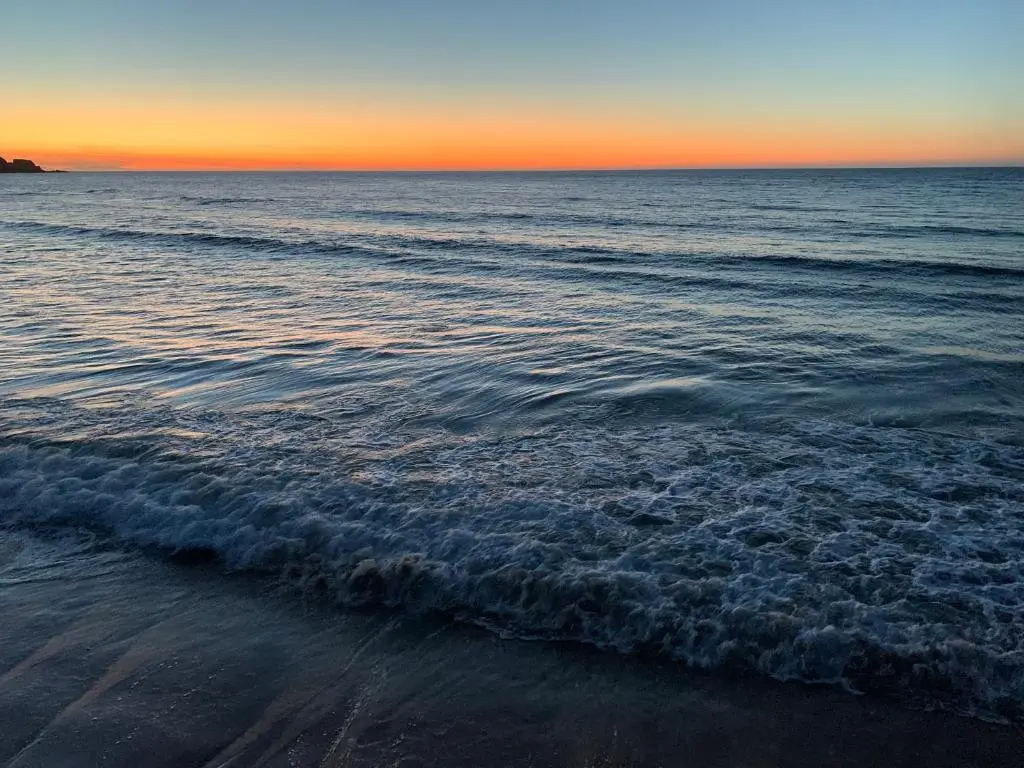 a view of the ocean from the beach at sunset at Serenity by the Sea in Buckie