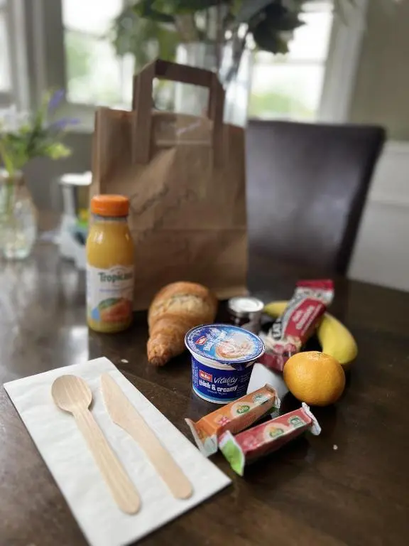 a table with a bag of bread and some food at The Shandwick Inn in Tain