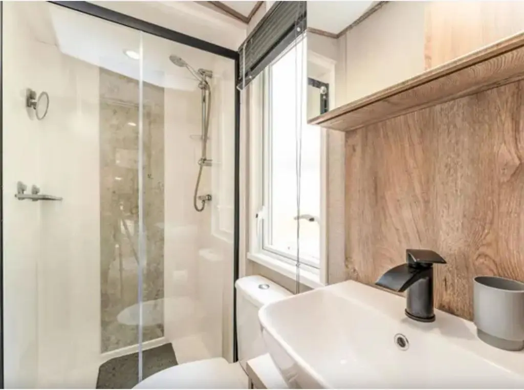 a bathroom with a toilet and a sink and a shower at ScottishHighlands in Boat of Garten