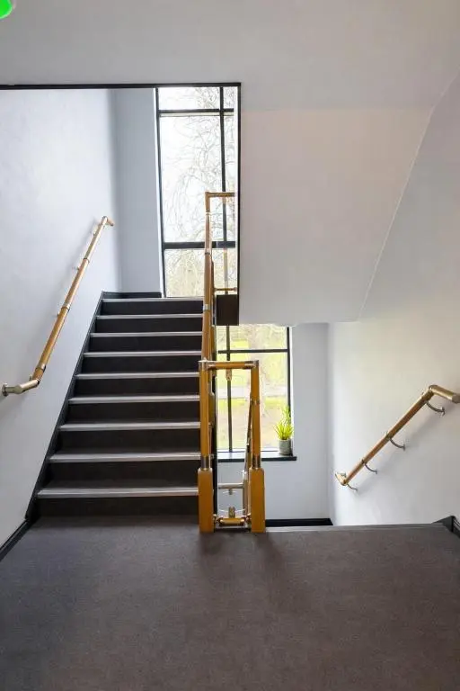 a staircase in a building with a stair case at Ness Garden in Inverness