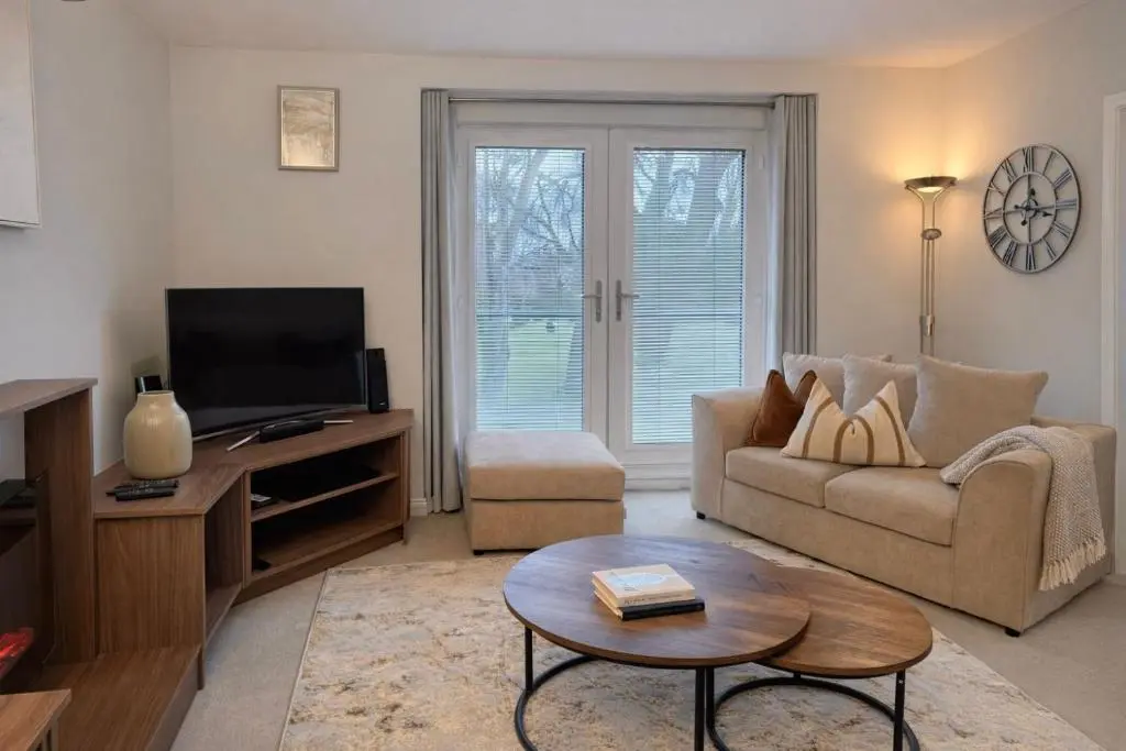 a living room with a couch and a tv at Ness Garden in Inverness