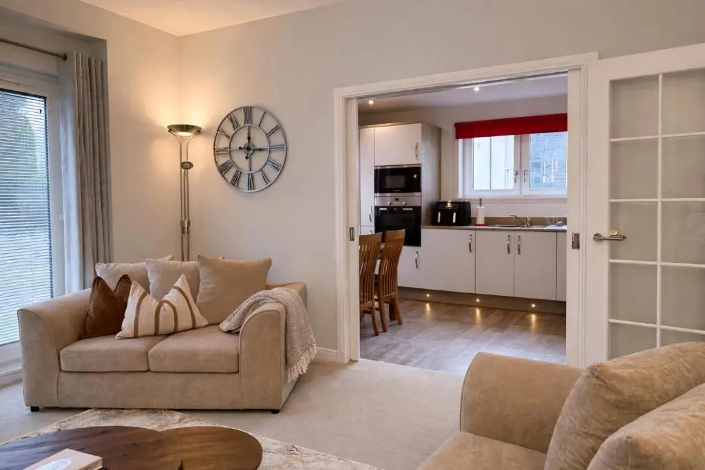 a living room with a couch and a table at Ness Garden in Inverness