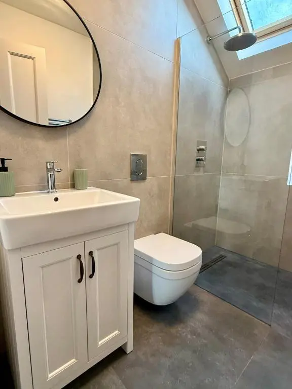a bathroom with a toilet and a sink and a shower at The Yellow Door in Inverness