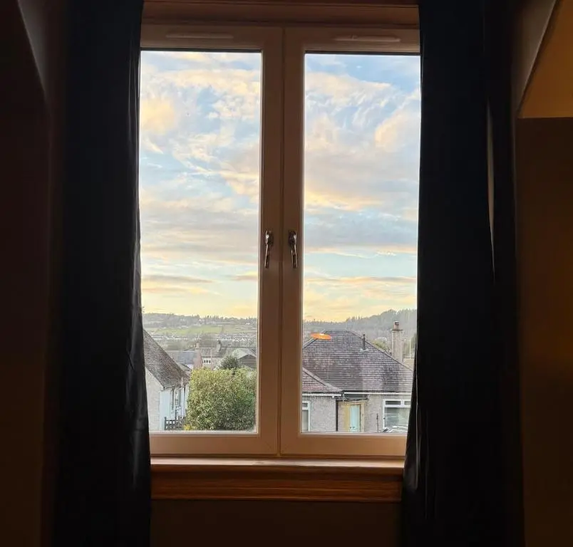 a window with a view of a city at The Yellow Door in Inverness
