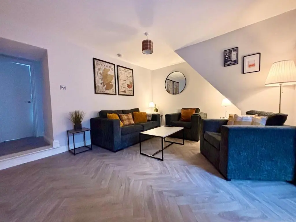 a living room with two couches and a table at Stunning Speyside retreat, ideal for Whisky lovers in Rothes