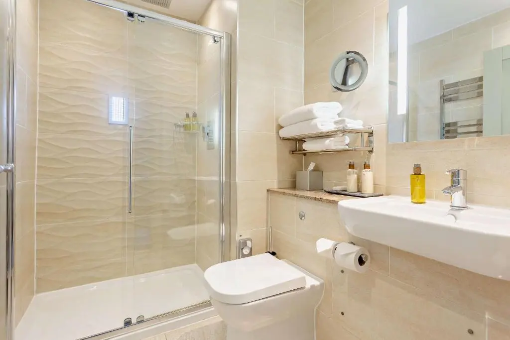 a bathroom with a shower and a toilet and a sink at Muckrach Country House in Skye of Curr