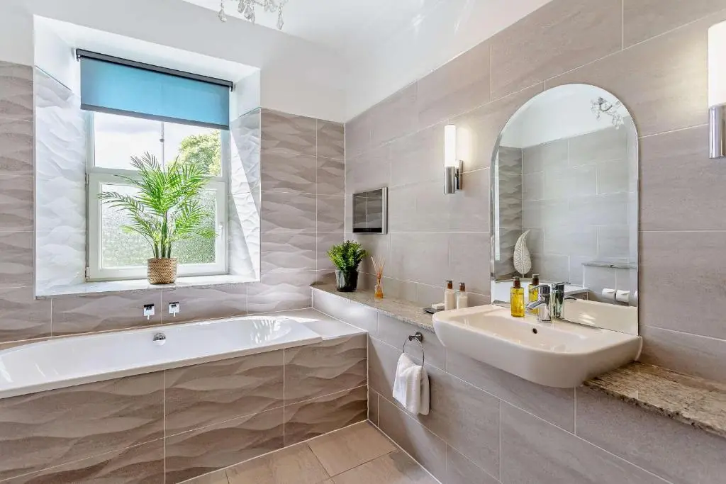 a bathroom with a tub and a sink and a window at Muckrach Country House in Skye of Curr