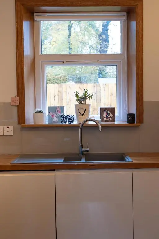 a kitchen counter with a sink and a window at Roos Cottage in Ellon