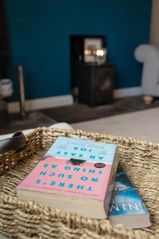two books in a basket on a table at Roos Cottage in Ellon