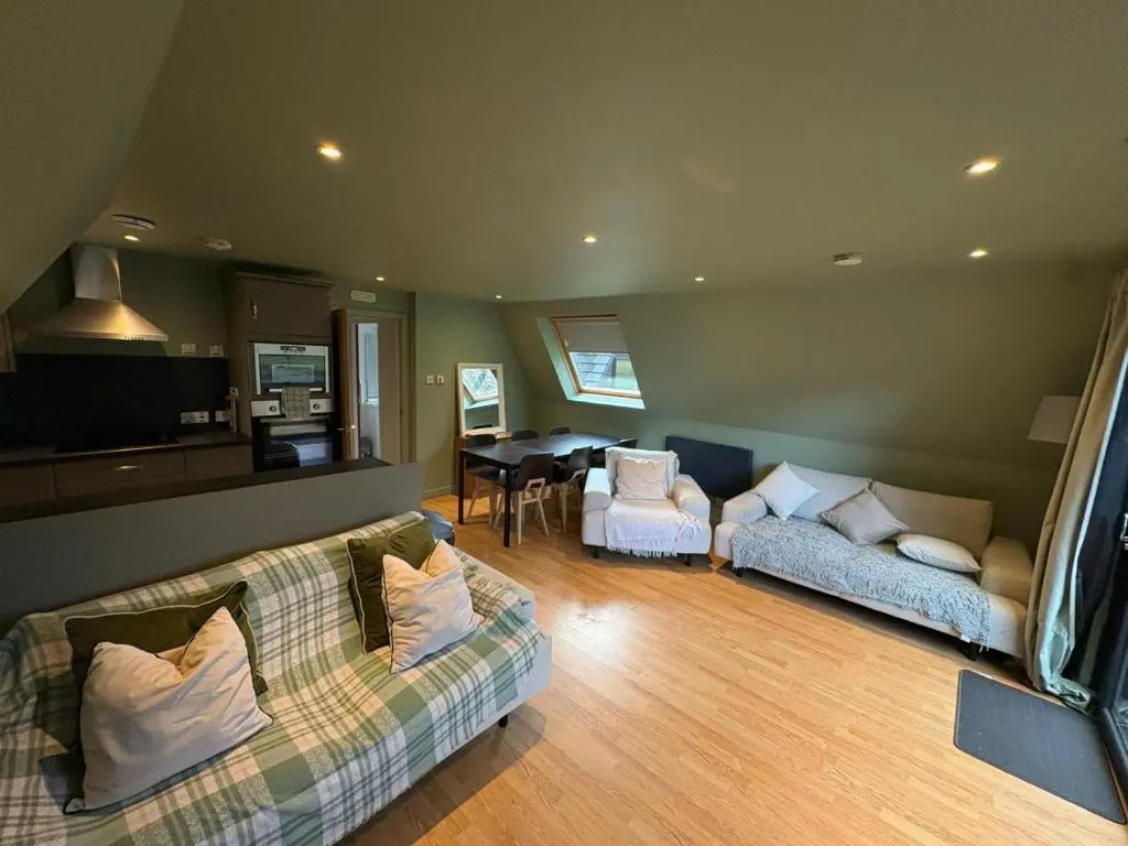 a living room with two couches and a table at The Great Glen Getaway Lodge in Spean Bridge