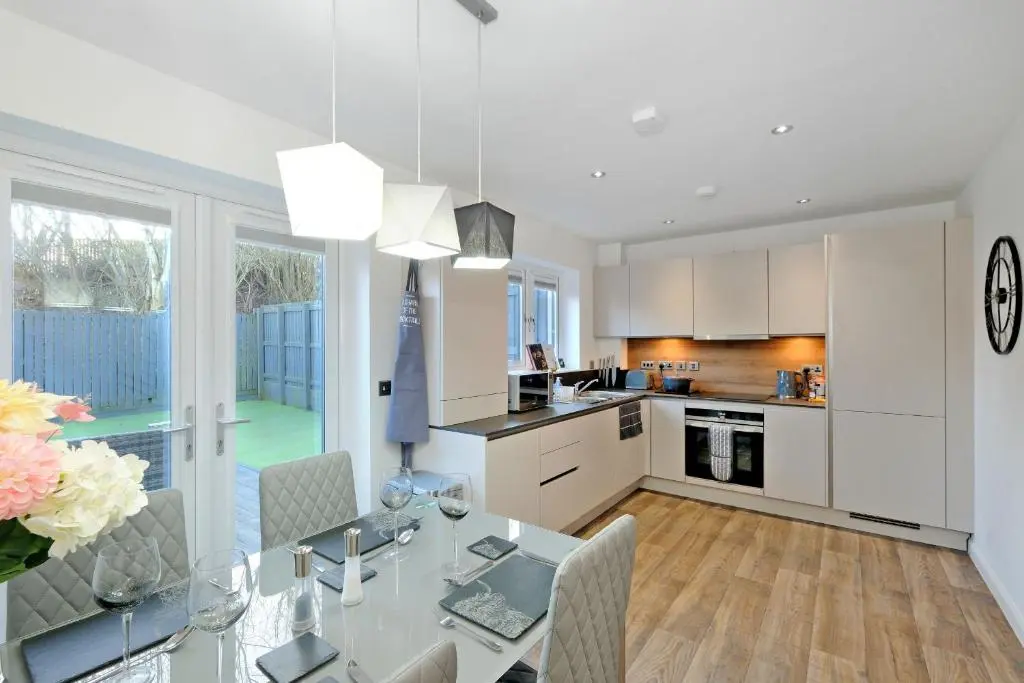 a kitchen and dining room with a glass table at A comfortable and modern 2BR 2BA home near ABZ in Inverurie