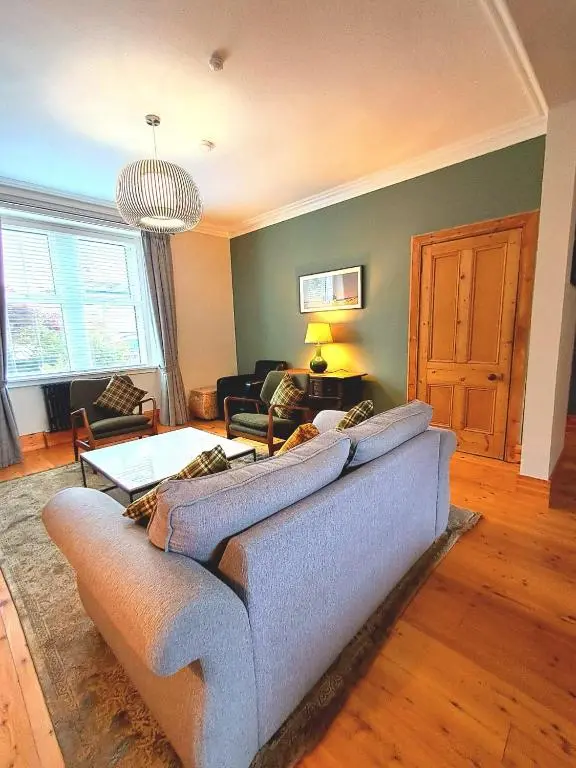 a living room with a couch and a table at 42 in the Crown in Inverness