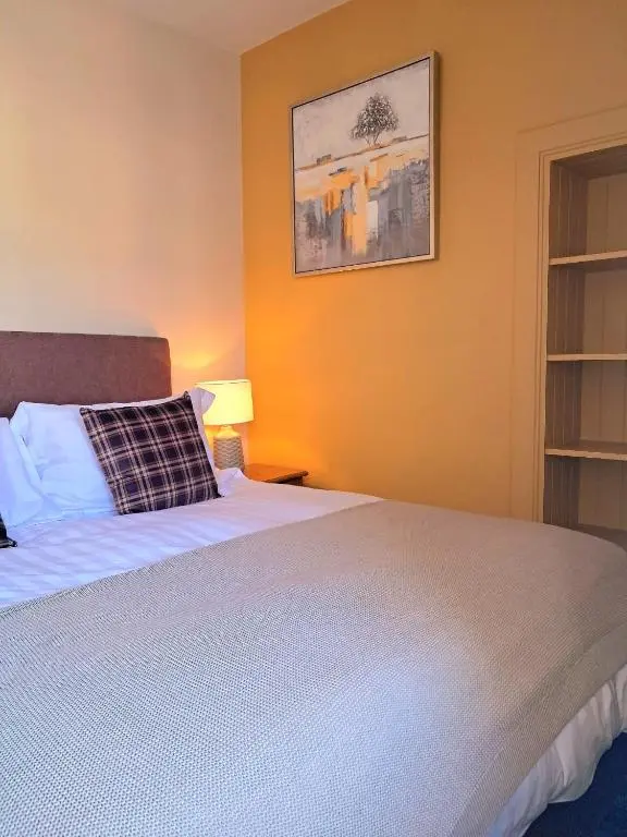 a bedroom with a bed and a picture on the wall at 42 in the Crown in Inverness