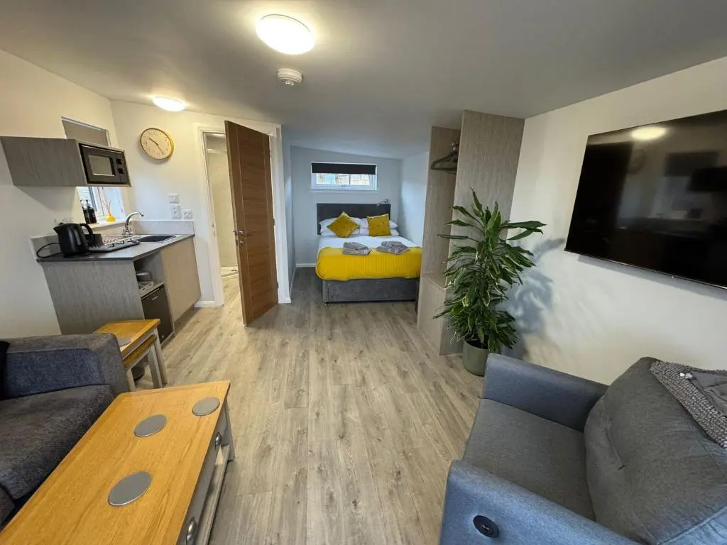 a small living room with a couch and a bed at Inverness Ardtower Escapes in Culloden