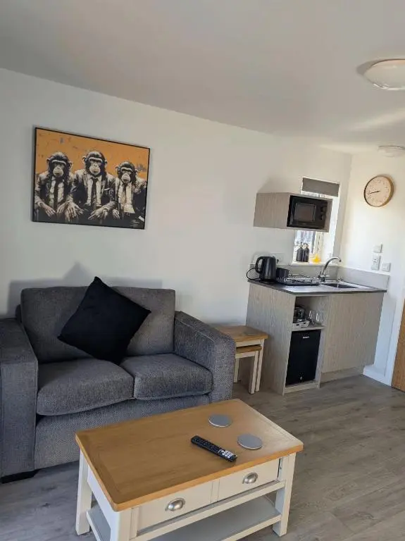 a living room with a couch and a table at Inverness Ardtower Escapes in Culloden