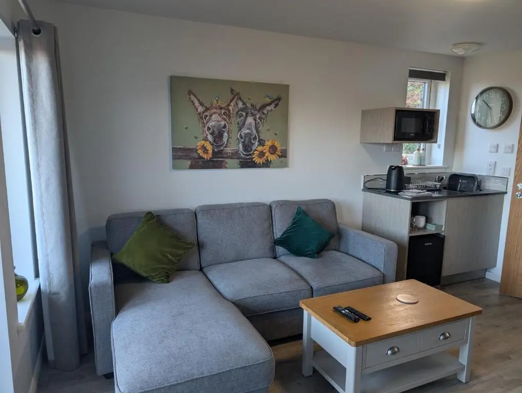 a living room with a couch and a table at Inverness Ardtower Escapes in Culloden