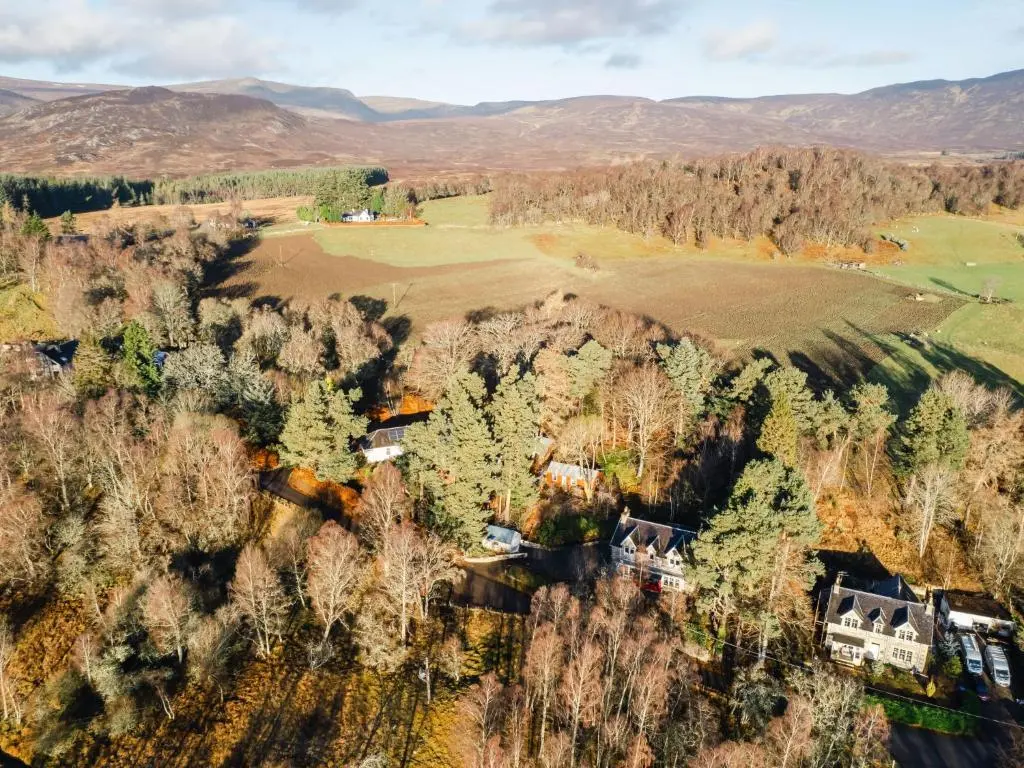 an aerial view of a house in a forest at Villa Netherwood by Interhome in Newtonmore
