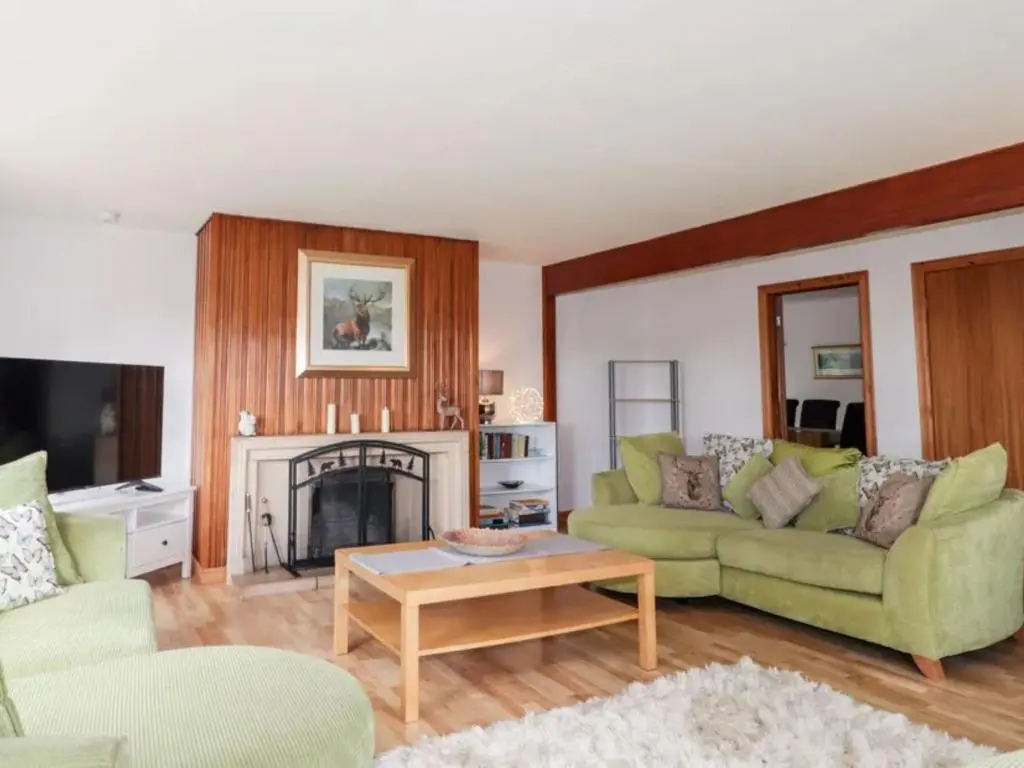 a living room with a couch and a fireplace at Holiday Home Greenaway by Interhome in Skye of Curr