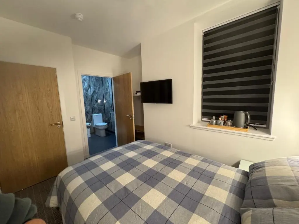 a bedroom with a bed and a window at TSB Rooms in Turriff