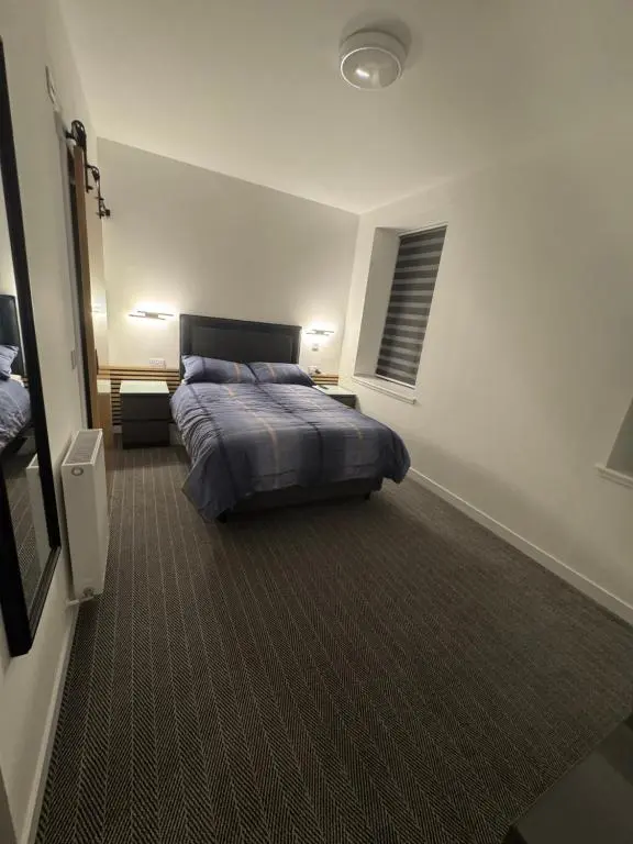 a bedroom with a bed and a window in it at TSB Rooms in Turriff